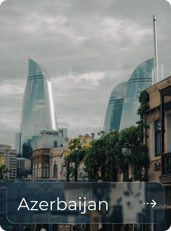 Modern skyscrapers in Baku, Azerbaijan with cloudy sky background.