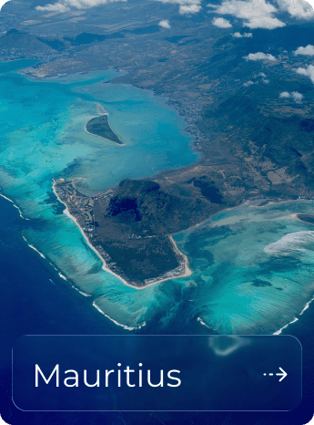 Aerial view of Mauritius island with turquoise waters and lush green landscape.